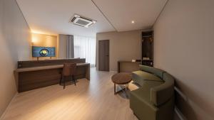 a living room with a couch and a table at Central Seven Hotel by Kwon Busan Seomyeon in Busan