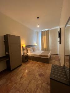 a bedroom with a bed and a dresser at Chambre meublée in Nice
