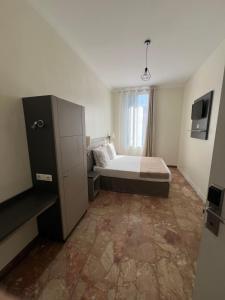 a bedroom with a bed and a large window at Chambre meublée in Nice