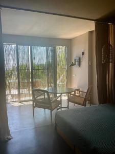a room with a bed and a table and chairs at Residenza Rosso Di Sera in Capoliveri