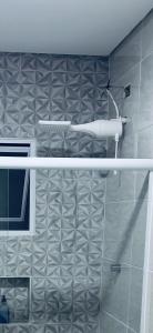 a shower in a bathroom with a gray tile wall at Refúgio dos ventos in Campos do Jordão +28 photos