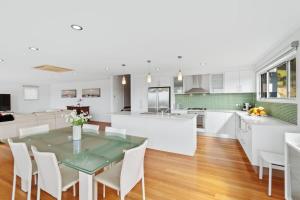 a kitchen and dining room with a table and chairs at Three Sisters at Long Beach in Long Beach