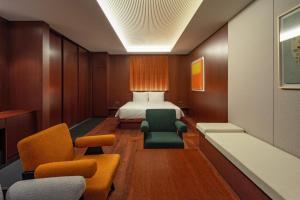 a hotel room with a bed and chairs at Haeundae Beach Restfield in Busan +31 photos