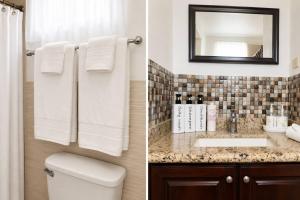 a bathroom with a toilet and a sink and a mirror at The Hideaway Suite, largest master, ocean glimpse in Florence Hall +8 photos