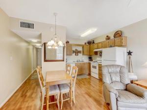 a kitchen and living room with a table and a couch at Whispering Pines 111 Lazy Bear in Pigeon Forge