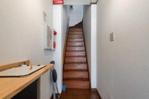 a hallway with a wooden staircase in a room at Guest House Wa N Wa in Osaka +26 photos