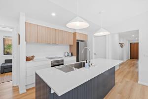 a kitchen with a white counter top and a sink at Tranquil at Rosedale in Tomakin