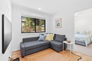 a living room with a couch and a bed at Tranquil at Rosedale in Tomakin