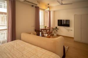 a living room with a couch and a television at Casa Lucia in Pune