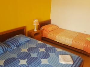 a bedroom with two beds and a lamp in it at Buljarica Bay Apartments in Petrovac na Moru