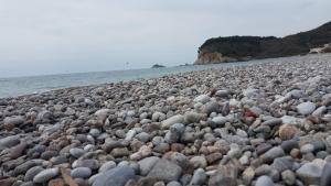 a large group of rocks on a beach at Buljarica Bay Apartments in Petrovac na Moru