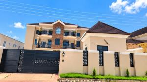 a house with a black fence in front of it at The Rehoboth in Sakumona
