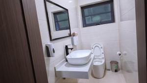 a bathroom with a toilet and a sink and a window at The Rehoboth in Sakumona +21 photos