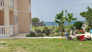 a yard of a house with a table and a garden at Buljarica Bay Apartments in Petrovac na Moru
