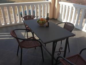 a table with a bowl of fruit on a balcony at Buljarica Bay Apartments in Petrovac na Moru