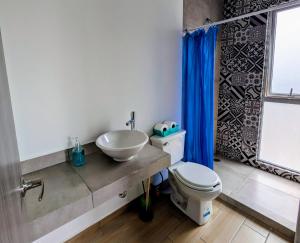 a bathroom with a sink and a toilet at Chepicche Inn in Oaxaca City
