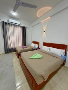 a bedroom with two beds in a room at El-Rabee Hotel in Al Aqālitah