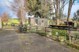 a tiny house in a field with a fence at Wahi Marie X by Tiny Away in Puketitiri
