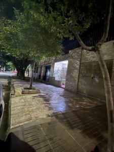 a sidewalk with trees in front of a building at Casa Chicho in Santiago del Estero