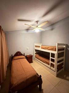 a bedroom with two bunk beds and a ceiling fan at Kusi 51 in La Banda +6 photos