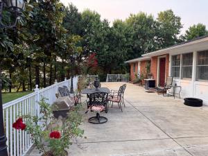 a patio with a table and chairs and a fence at National Harbor Guesthouse in Fort Washington