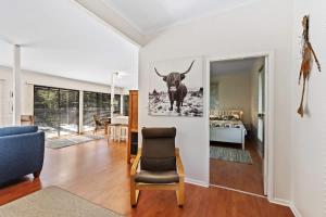 a living room with a picture of a bull on the wall at The Treehouse at Long Beach in Long Beach