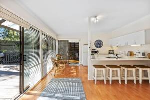 a kitchen with a counter and some chairs in a room at The Treehouse at Long Beach in Long Beach