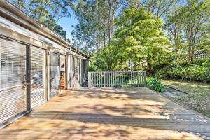 a wooden walkway leading to a house with a gate at The Treehouse at Long Beach in Long Beach +8 photos