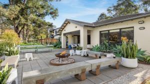 a backyard with a fire pit and a house at Hunter Grange - The Vintage in Pokolbin
