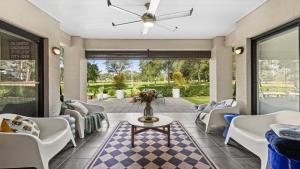 a living room with couches and a table at Hunter Grange - The Vintage in Pokolbin