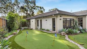a house with a golf course in front of it at Hunter Grange - The Vintage in Pokolbin