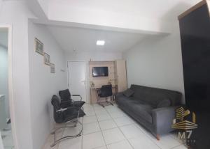 a living room with a couch and chairs at Loft Ponta Aguda in Blumenau