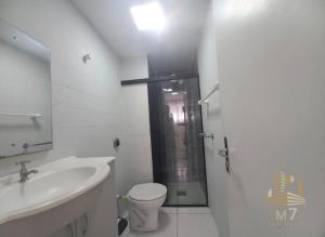 a bathroom with a sink and a toilet and a shower at Loft Ponta Aguda in Blumenau