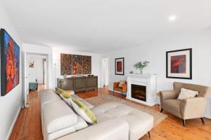 a living room with a white couch and a fireplace at Long Beach Hideaway in Long Beach