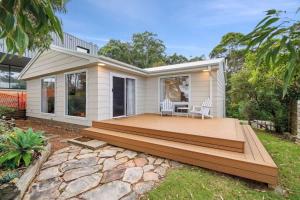 a house with a wooden deck in the backyard at Long Beach Hideaway in Long Beach +15 photos
