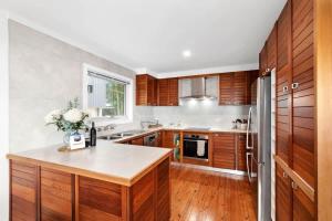 a kitchen with wooden cabinets and a counter top at Long Beach Hideaway in Long Beach