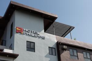 a hotel philippine sign on the side of a building at Hotel Philippe Palo in Palo