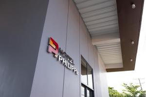a building with a train sign on the side of it at Hotel Philippe Palo in Palo +5 photos