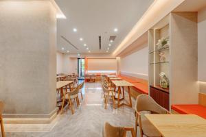 a restaurant with wooden tables and chairs at Whiyori Inn in Kaohsiung +61 photos
