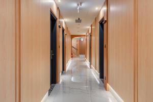 a hallway with wooden walls and a long corridor with white marble floors at Whiyori Inn in Kaohsiung