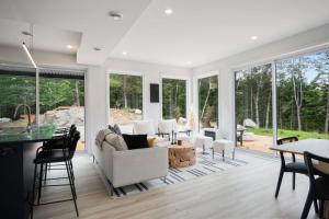 a living room with white furniture and large windows at Ultra Luxurious Modern Chalet Private Jacuzzi in La Conception