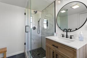 a bathroom with a sink and a shower with a mirror at Riverview Bliss in Beautiful Home in Pulaski +19 photos