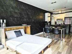 a bedroom with a white bed and a black wall at Le201 Condo Chic Free Parking in Quebec City