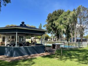 a pavilion with a picnic table in a park at Young Tourist Park in Young