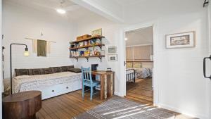 a bedroom with a bed and a table in a room at 19 Newry St in Nambucca Heads