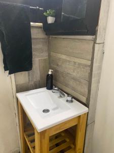 a bathroom sink with a black towel hanging above it at Departamento Patri in General Pico