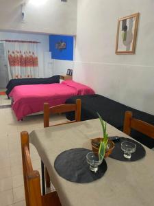 a room with a dining table and a bed at Departamento Patri in General Pico