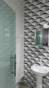 a white bathroom with a sink and a mirror at Pousada 48 Graus - Caldas do Jorro BA in Poço Redondo +64 photos