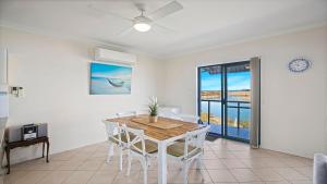 a dining room with a table and chairs at Mountains By The Sea in Nambucca Heads