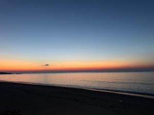 a view of the beach at sunset with the ocean at apart iconmall SL in Singopadu
